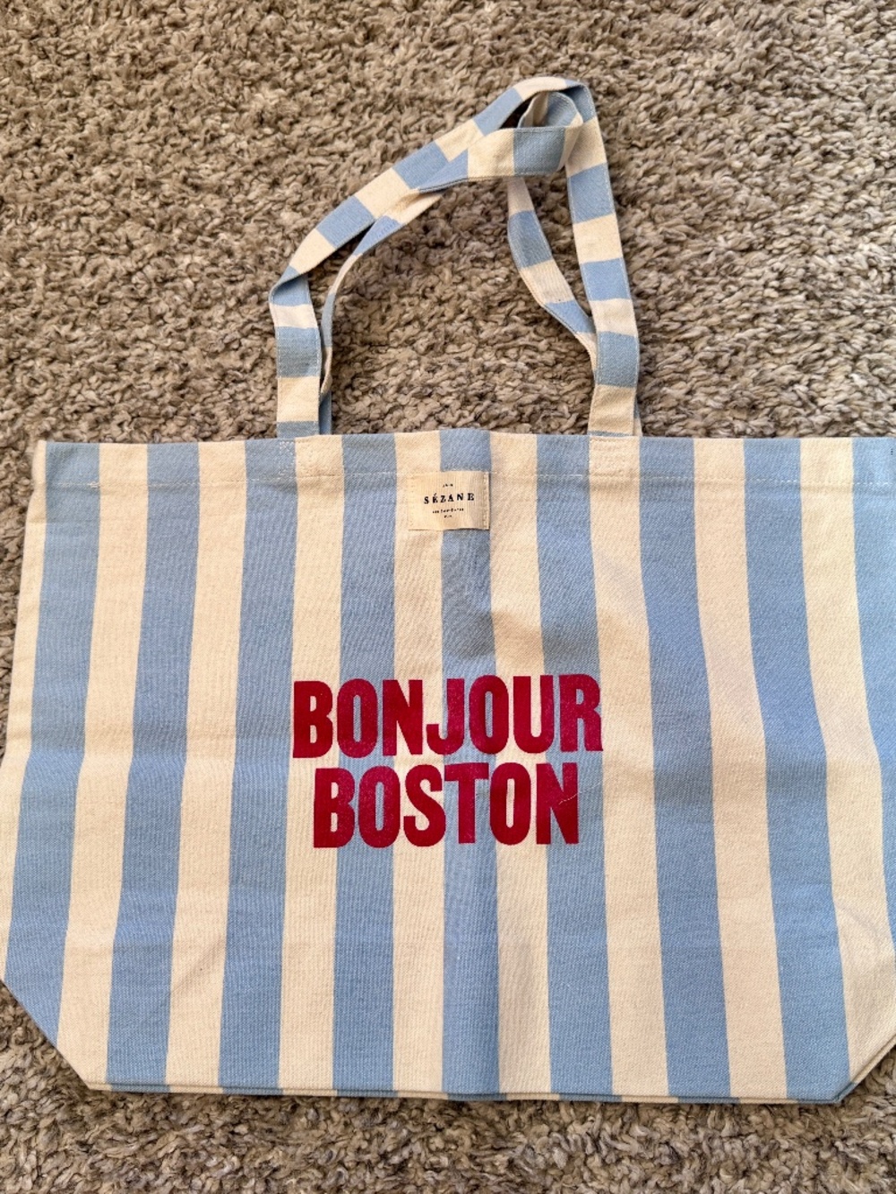 Limited edition Sézane Bonjour Boston canvas tote bag in blue and white stripes.